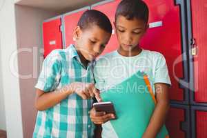 Boys with smartphone in the corridor