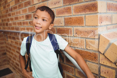 Smiling schoolboy looking away