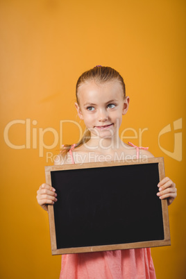 Little girl holding a blackboard