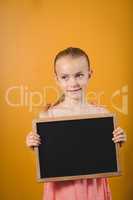Little girl holding a blackboard