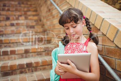Brunette schoolgirl looking her digital tablet