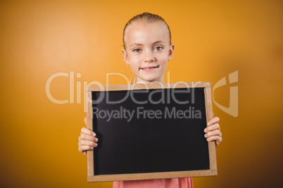 Little girl holding a blackboard