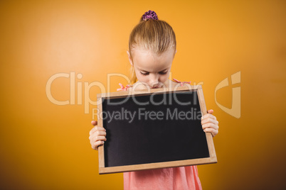 Blonde girl holding a blackboard