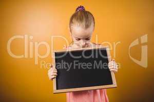 Blonde girl holding a blackboard
