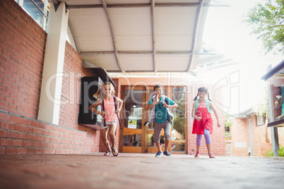 Three kids running in the playground