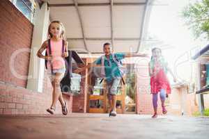 Three kids running in the playground