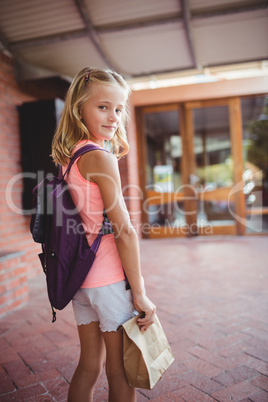 Cute little girl holding her launch bag