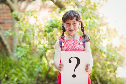 Girl holding a sign with a question mark