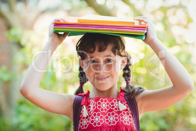 Brunette girl with books on her heads