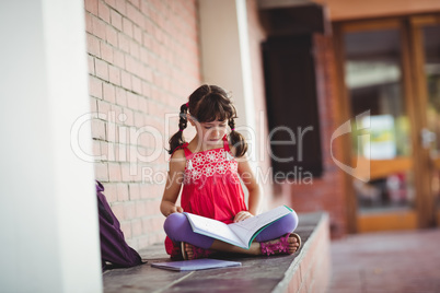 Girl reading a book outside