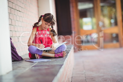 Girl writing in a book