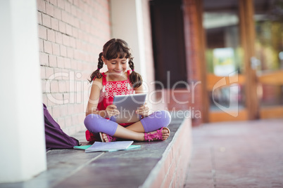 Girl looking at her digital tablet