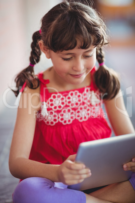 Girl looking at her digital tablet