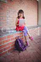 Schoolgirl looking at her digital tablet
