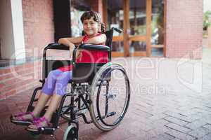 Smiling girl siting in a wheelchair