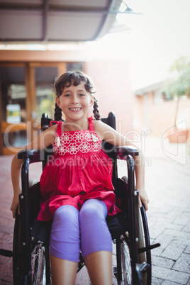 Smiling girl siting in a wheelchair