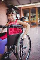 Smiling girl siting in a wheelchair