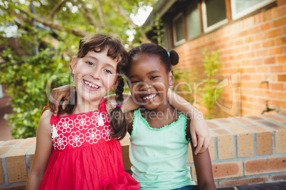 Two friendly girl posing and smiling