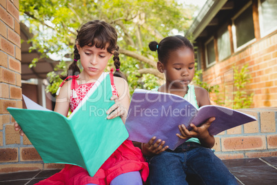 Two children looking their book