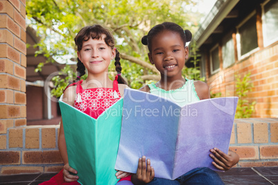 Two children holding a book