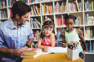 Children and dad at the library