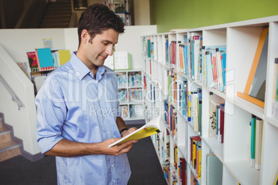 Handsome man reading a book