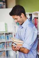 Handsome man holding books