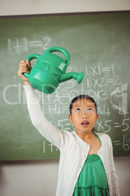 Schoolgirl using a watering can