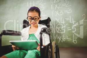 Seated little girl looking at her digital tablet