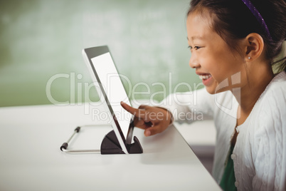 Smiling girl using digital tablet