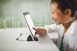 Smiling girl using digital tablet