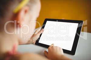 Little girl pointing and using a digital tablet