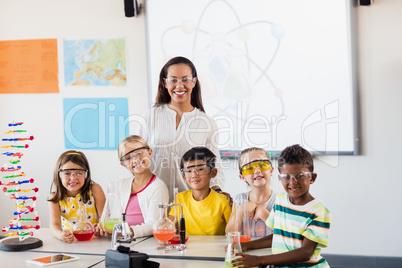 Happy teacher and pupils posing for the camera