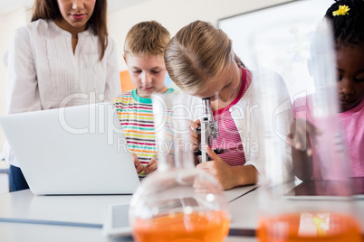 Pupil looking through a microscope