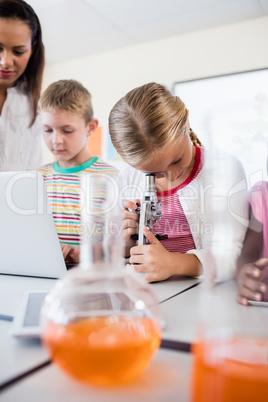 Pupil looking through a microscope