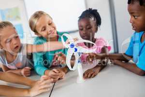 Pupils touching a wind turbine model