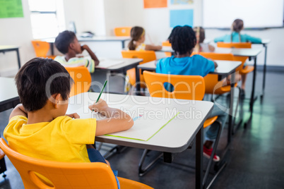 Pupils working at their desk in class