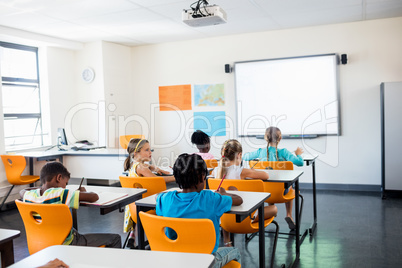 Rear view of pupils working in classroom