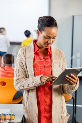 Portrait of a teacher using tablet pc in class