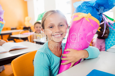 Portrait of a smiling pupil receiving a gift box