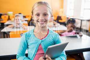 A cute pupil posing with tablet pc