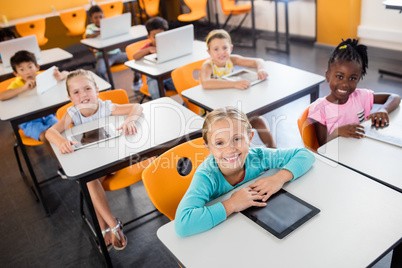 Close up view of pupils studying with laptop and tablet pc