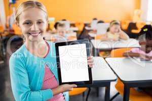 portrait of smiling pupil standing with tablet pc