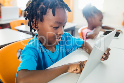 Pupil using a tablet pc in classroom