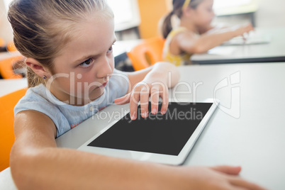 Close up view of pupil using tablet pc at desk