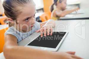 Close up view of pupil using tablet pc at desk