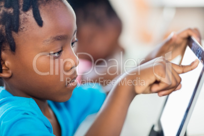 extreme close up view of pupil using tablet pc at desk