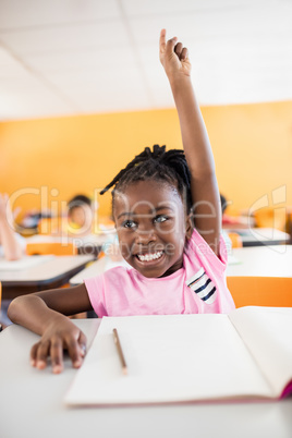 A cute pupil raising hand