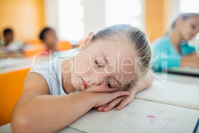 A cute girl falling asleep at desk