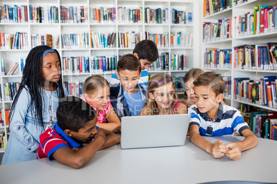 Front view of pupils studying with laptop